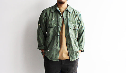 【SHANANA MIL】60-70s Remake OG-107Utility Shirts.無骨な雰囲気に花を刺繍したセンスの良い1枚。